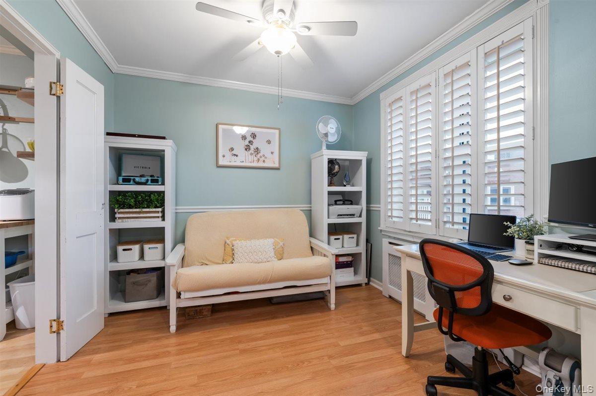700 Shore Road, Unit 7Y Long Beach, NY 11561 - Photo 7 of 31 Home office featuring light wood finished floors, radiator, ornamental molding, and ceiling fan