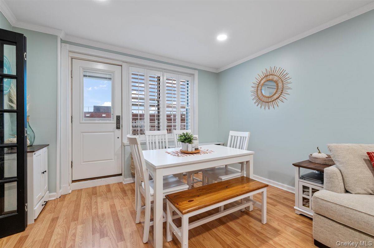 700 Shore Road, Unit 7Y Long Beach, NY 11561 - Photo 8 of 31 Dining room featuring crown molding, light wood-style flooring, and recessed lighting
