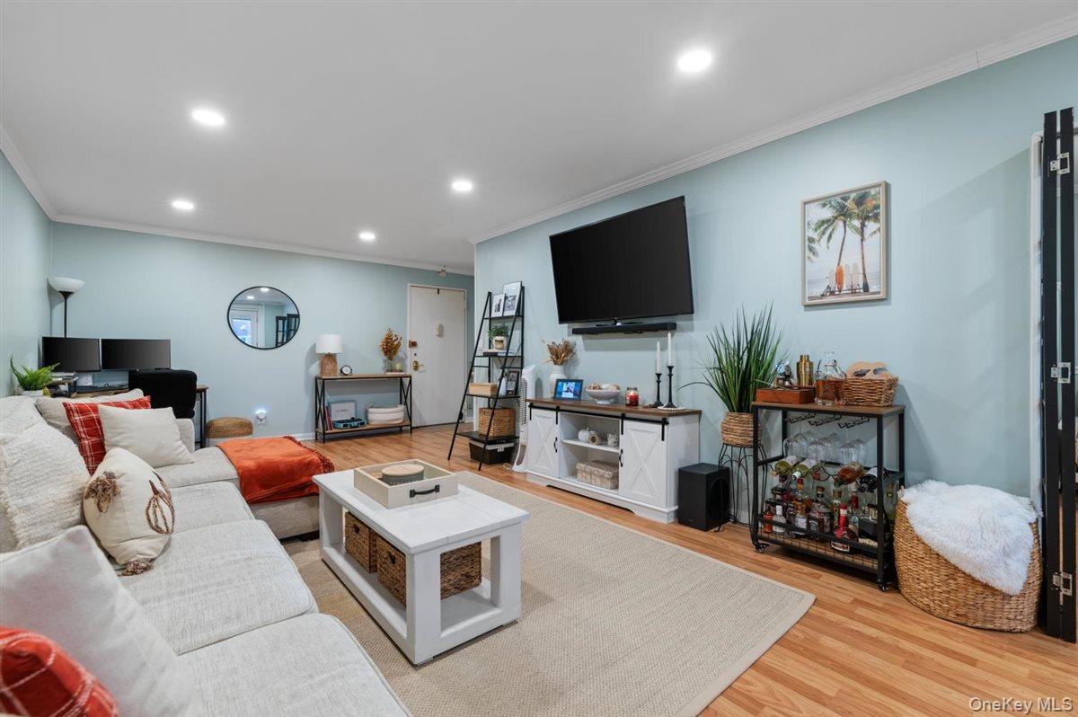 700 Shore Road, Unit 7Y Long Beach, NY 11561 - Photo 10 of 31 Living area with ornamental molding, light wood-style flooring, recessed lighting, and an office area