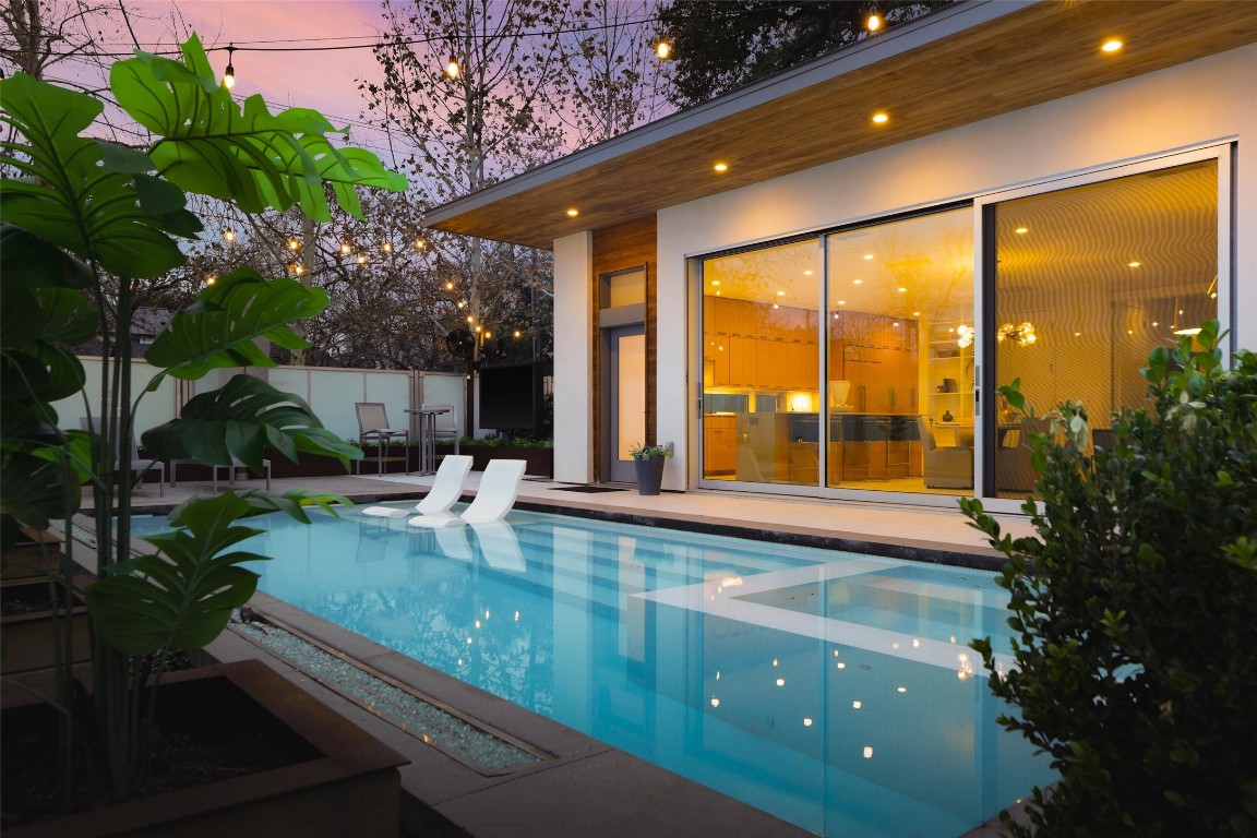 a swimming pool view with a garden space