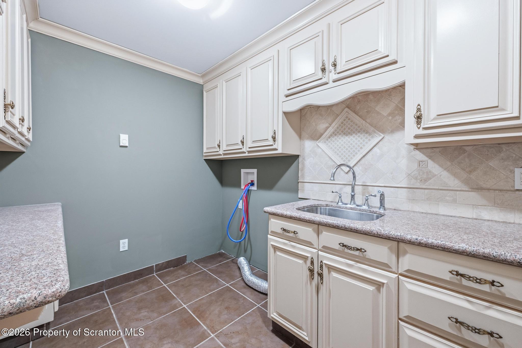116 Forge Street Old Forge, PA 18518 - Photo 14 of 49 a kitchen with kitchen island granite countertop appliances cabinets and a sink