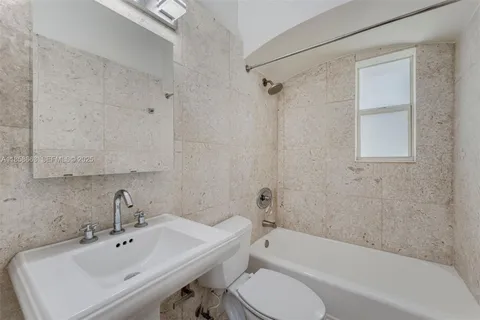 a bathroom with a sink toilet and bathtub