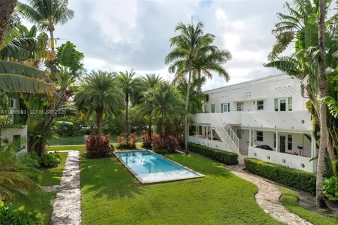 a view of house with yard and outdoor seating