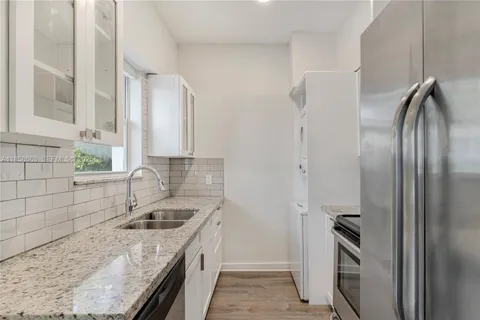 a kitchen with a sink stove and refrigerator
