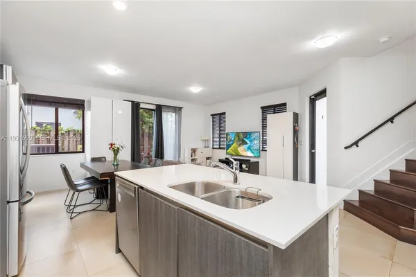 a kitchen with a sink and a refrigerator