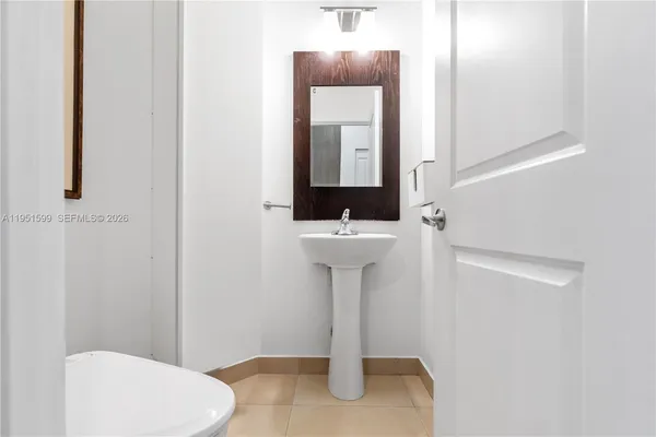a bathroom with a sink a toilet and mirror