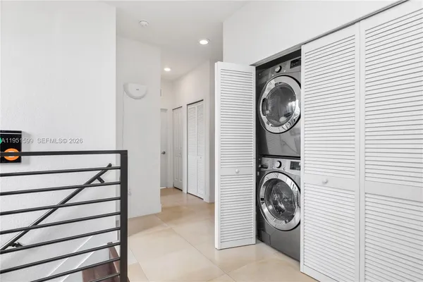 a view of a hallway with washer and dryer