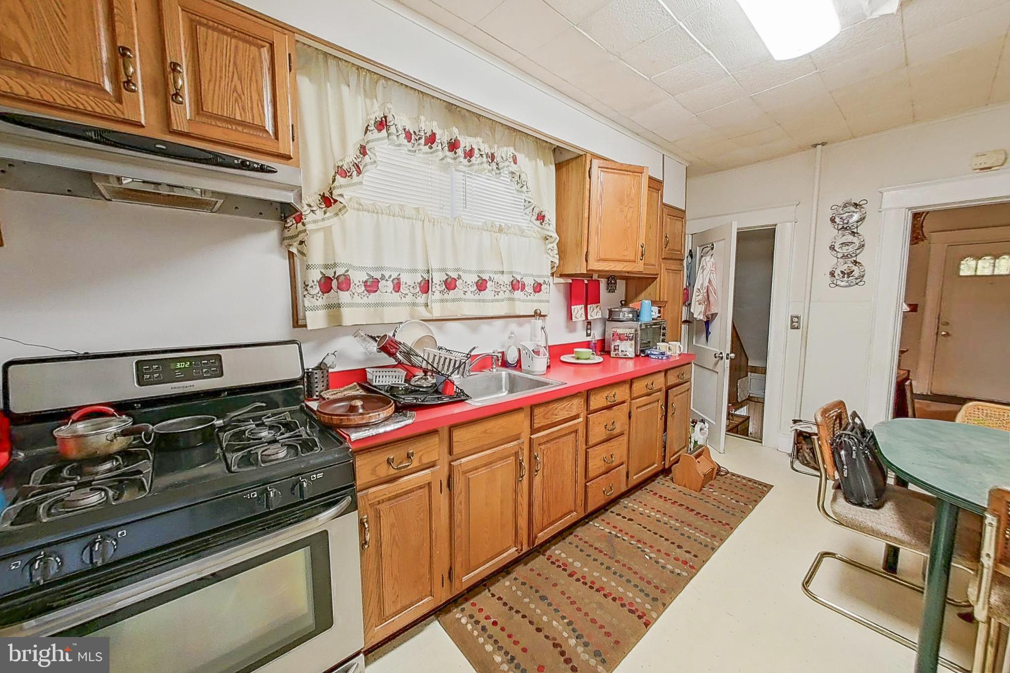 2803 Ruscombe Lane Baltimore, MD 21215 - Photo 9 of 28 a kitchen with stainless steel appliances granite countertop a stove and cabinets