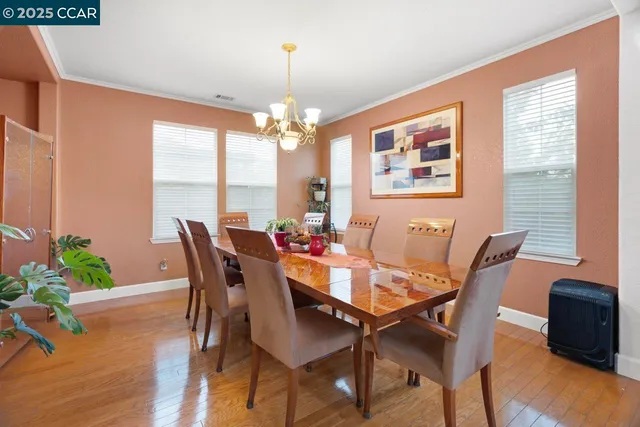 a kitchen with stainless steel appliances kitchen island granite countertop a refrigerator and cabinets