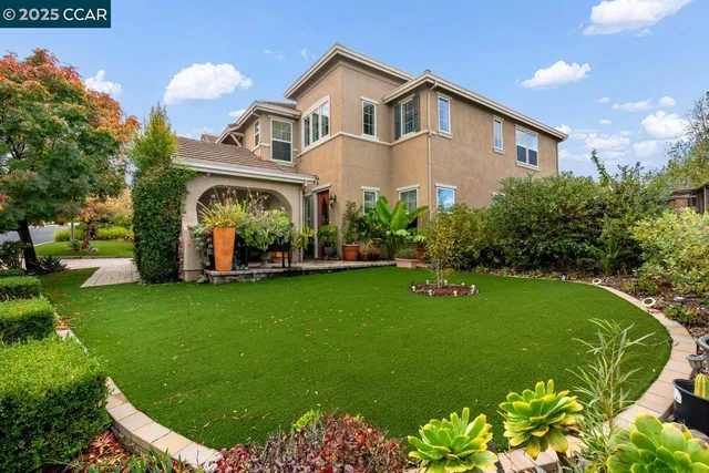 a front view of a house with garden