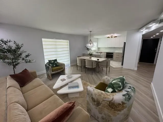 a living room with furniture or couch and a potted plant