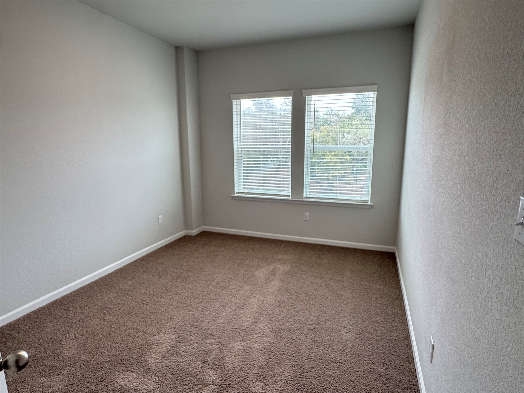 3000 Chisholm Trail Road, Unit 103 Round Rock, TX 78681 - Photo 26 of 32 Bedrroom 4 featuring a textured wall and carpet flooring