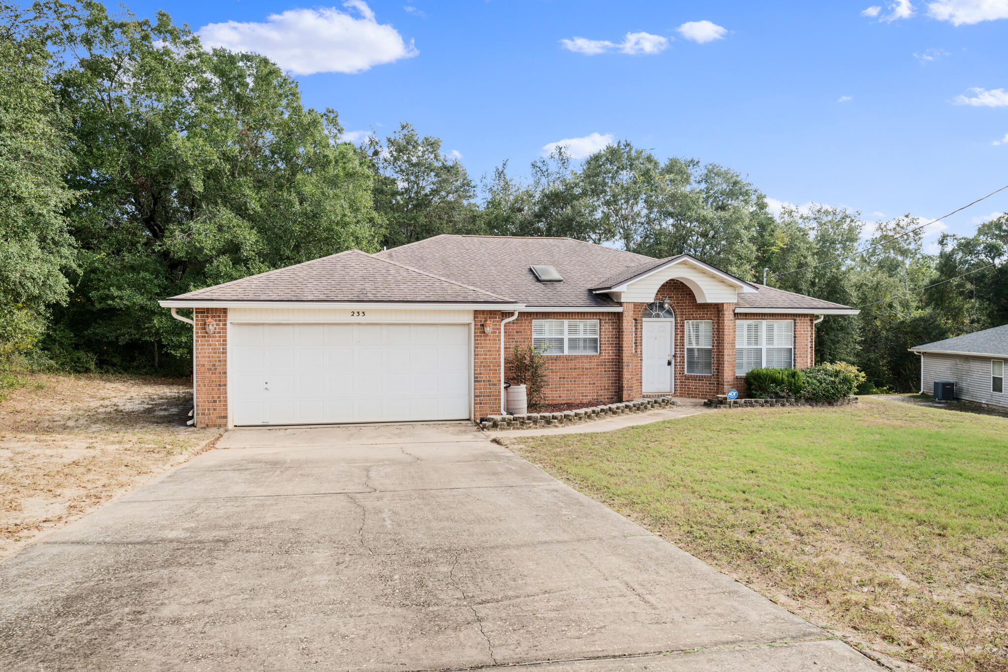 233 Lustan Drive Crestview, FL 32536 - Photo 1 of 22 a white house with a large yard and large trees
