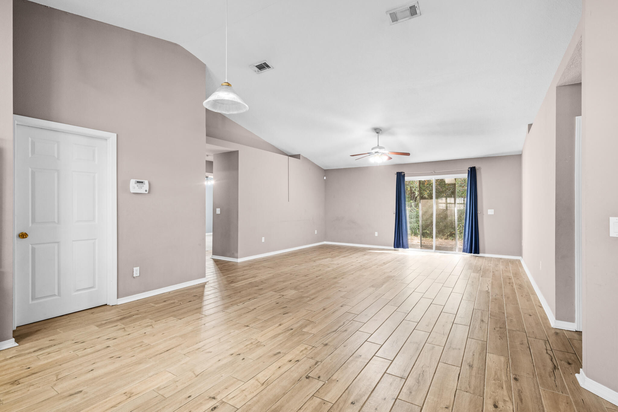 233 Lustan Drive Crestview, FL 32536 - Photo 11 of 22 a view of an empty room and window and wooden floor