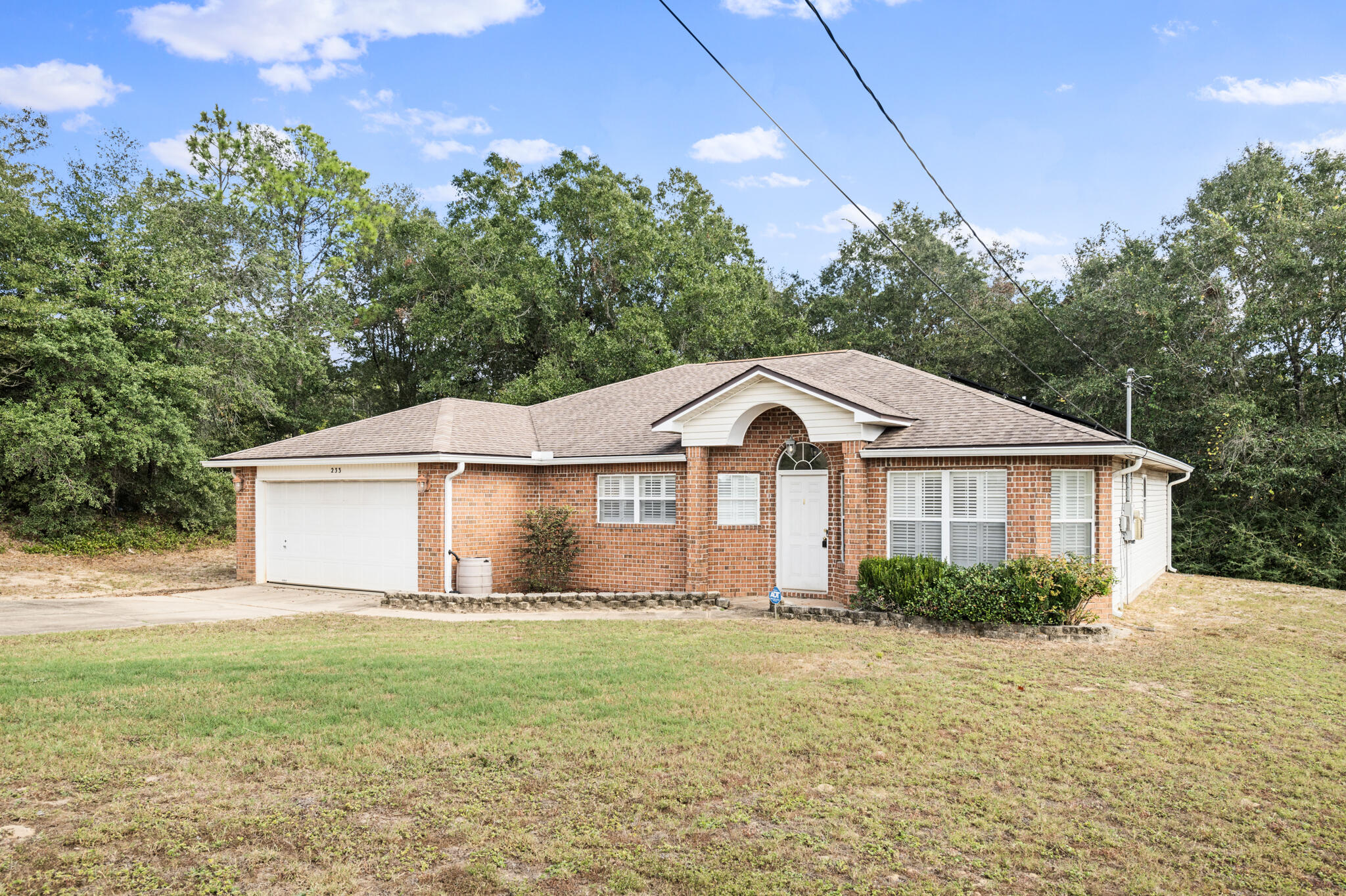 233 Lustan Drive Crestview, FL 32536 - Photo 2 of 22 a front view of a house with garden