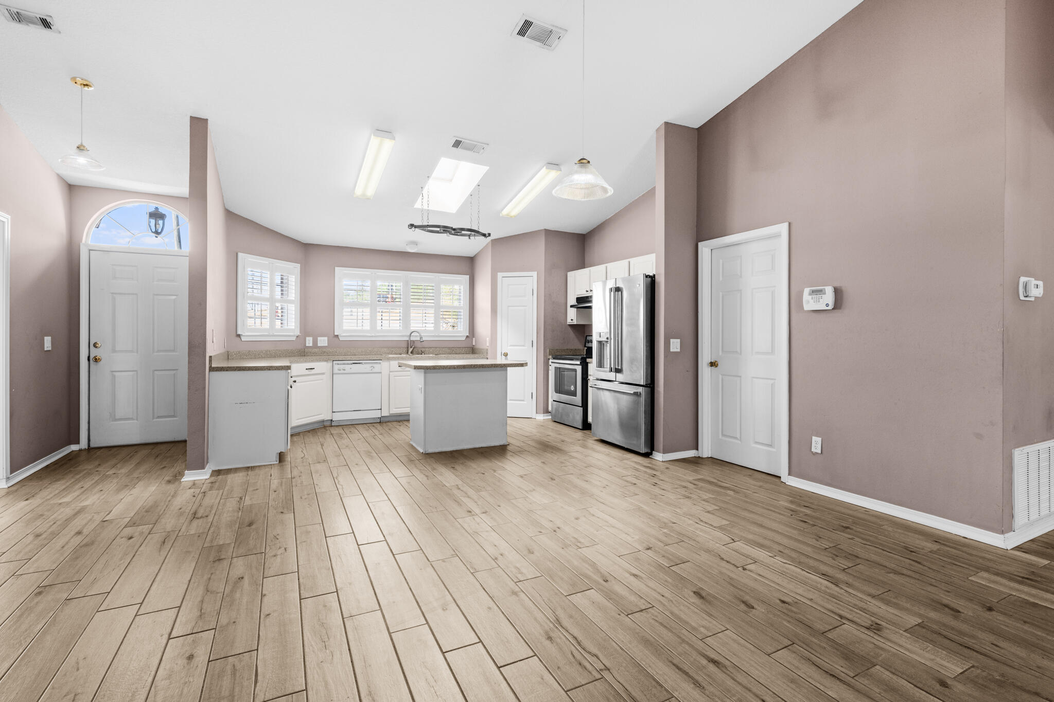 233 Lustan Drive Crestview, FL 32536 - Photo 6 of 22 a view of a kitchen with wooden floor and a sink