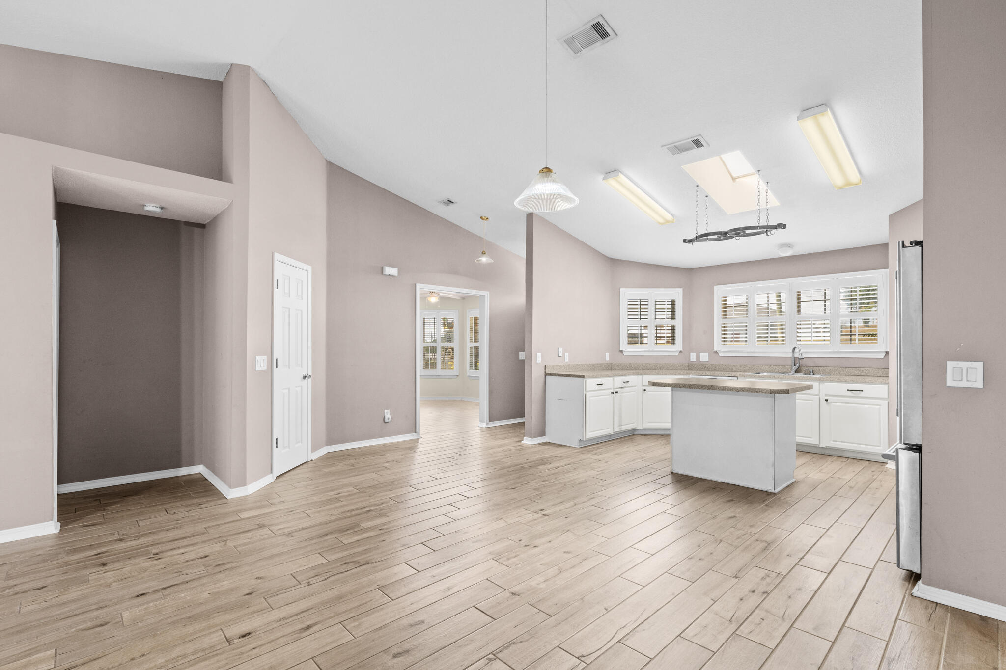 233 Lustan Drive Crestview, FL 32536 - Photo 8 of 22 a view of a kitchen with refrigerator and wooden floor