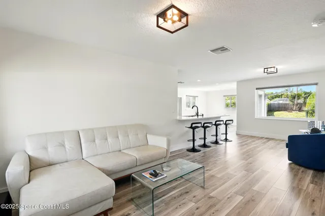a living room with furniture a rug and a window