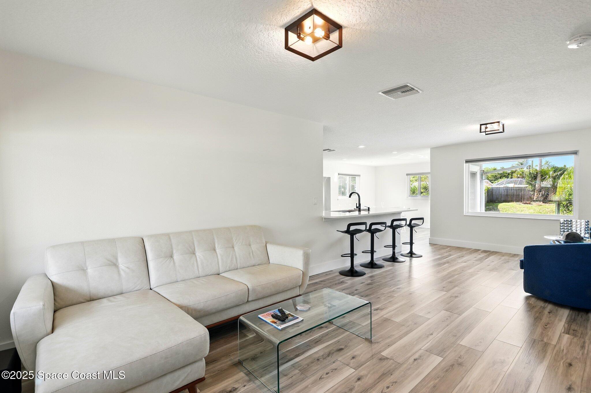 135 Richland Avenue Merritt Island, FL 32953 - Photo 11 of 24 a living room with furniture a rug and a window