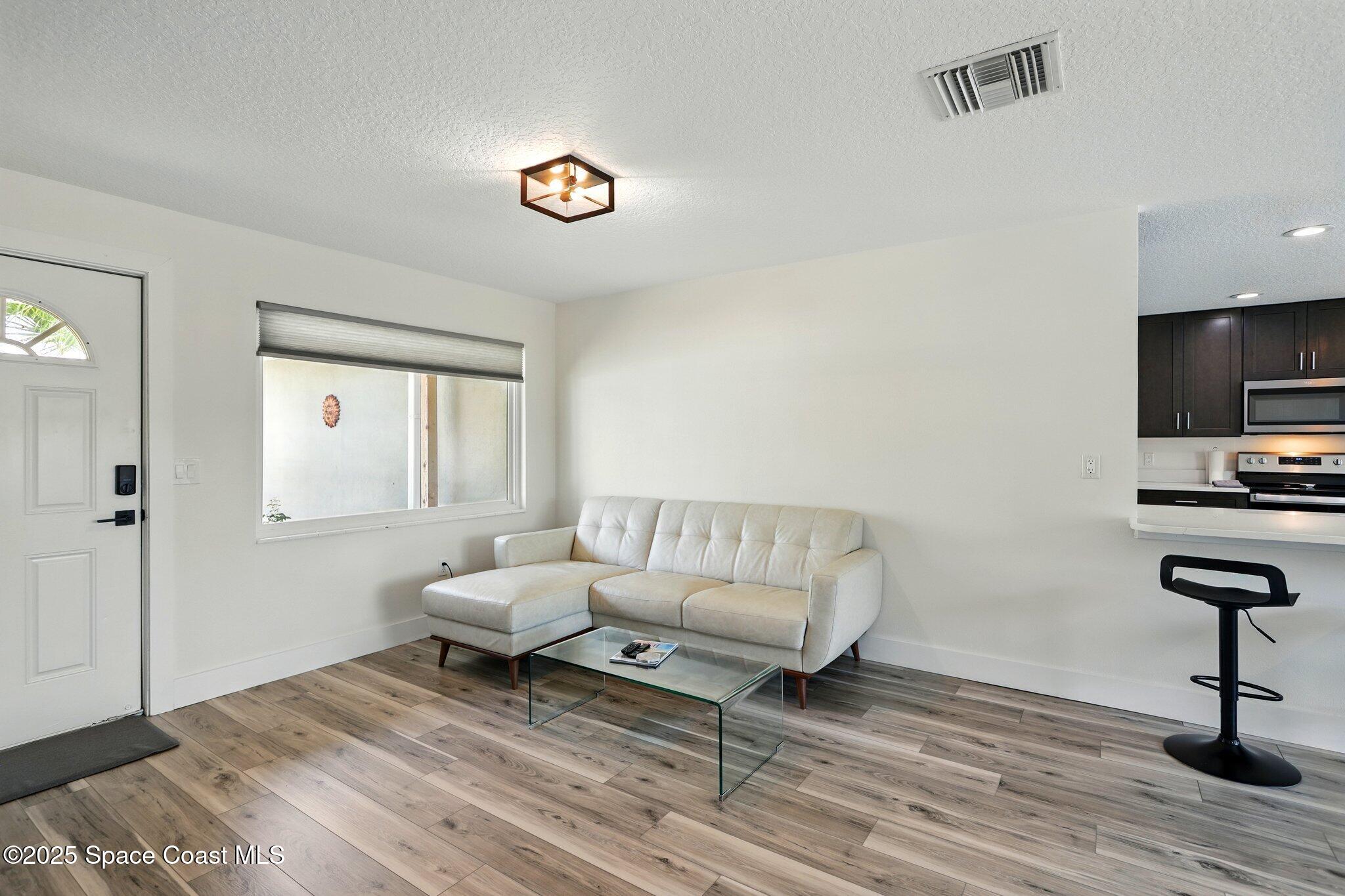 135 Richland Avenue Merritt Island, FL 32953 - Photo 12 of 24 a living room with furniture and a flat screen tv
