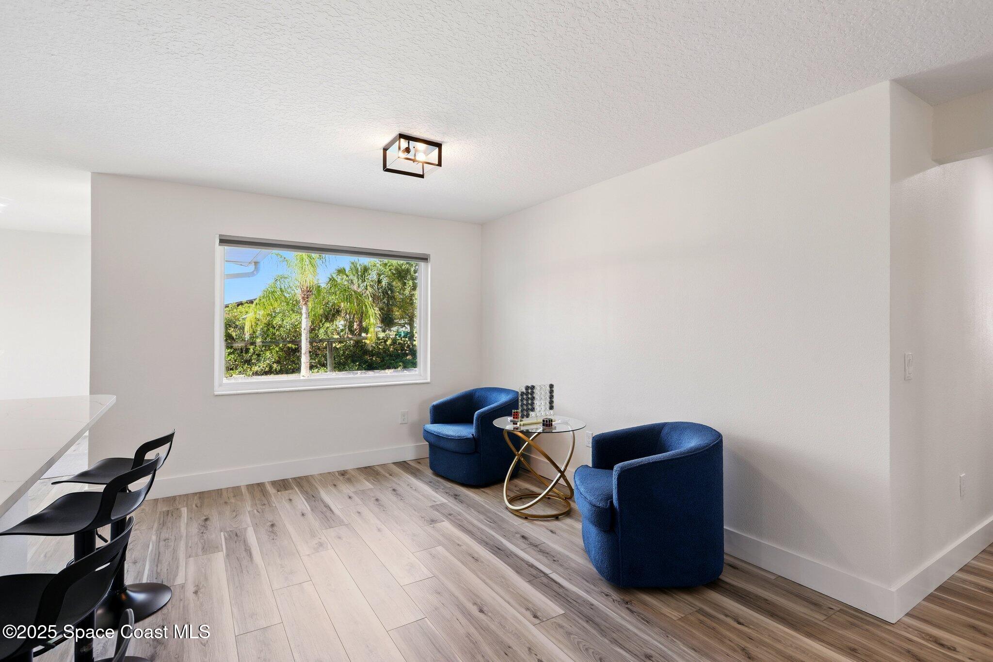 135 Richland Avenue Merritt Island, FL 32953 - Photo 13 of 24 a room with wooden floor and windows
