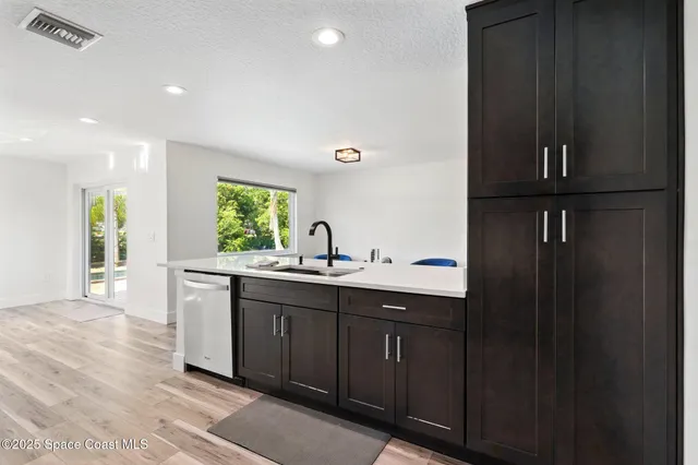 a kitchen with a sink and cabinets
