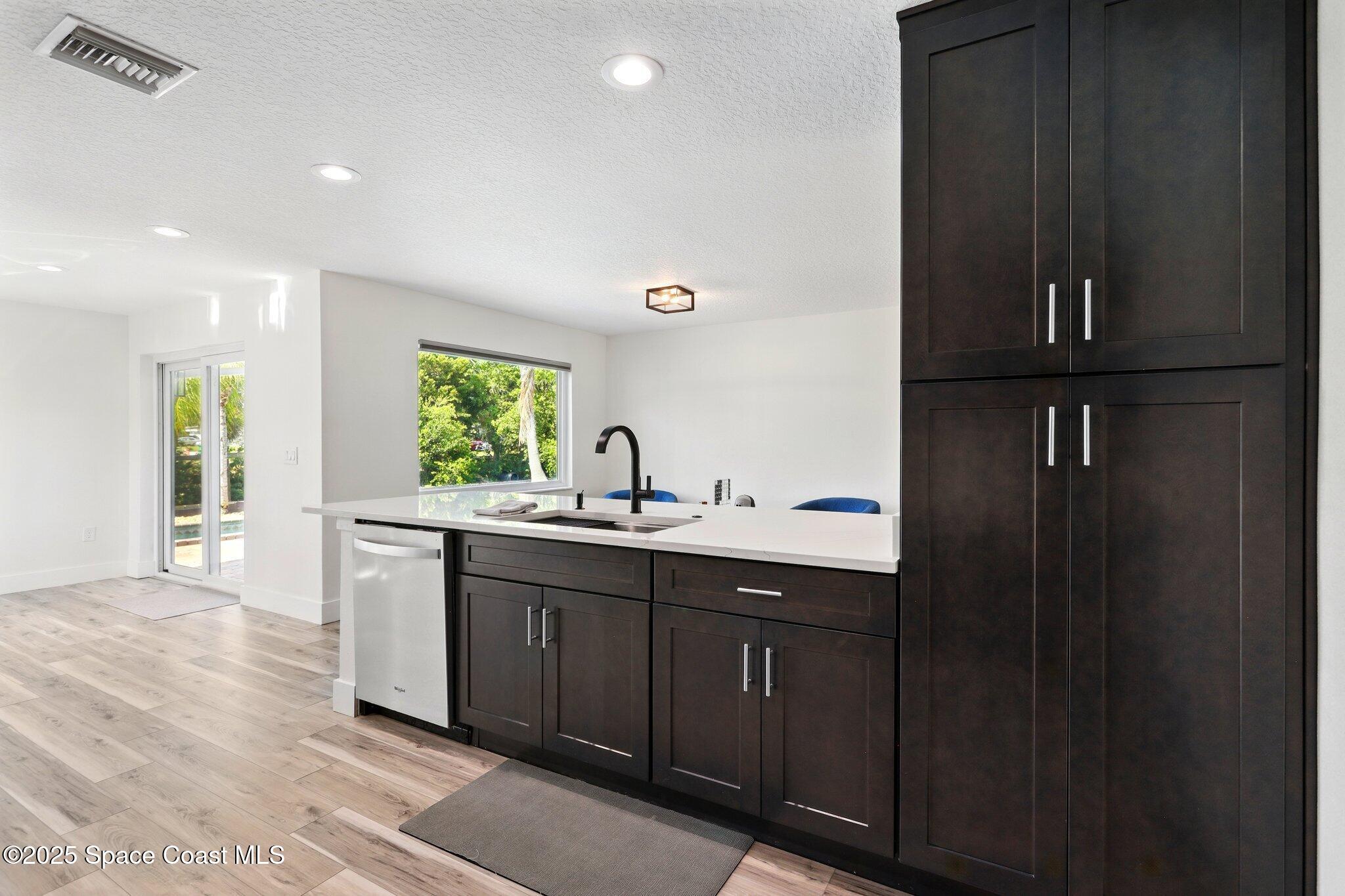 135 Richland Avenue Merritt Island, FL 32953 - Photo 17 of 24 a kitchen with a sink and cabinets