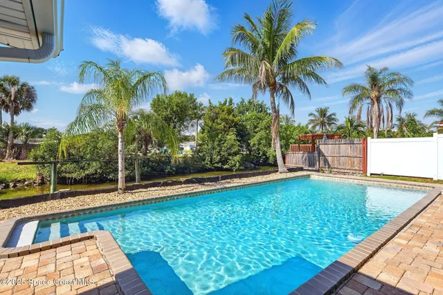 a view of swimming pool with a patio and a yard