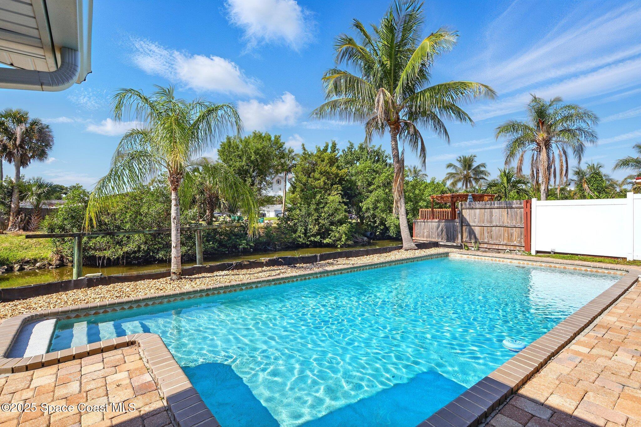 135 Richland Avenue Merritt Island, FL 32953 - Photo 3 of 24 a view of swimming pool with a patio and a yard