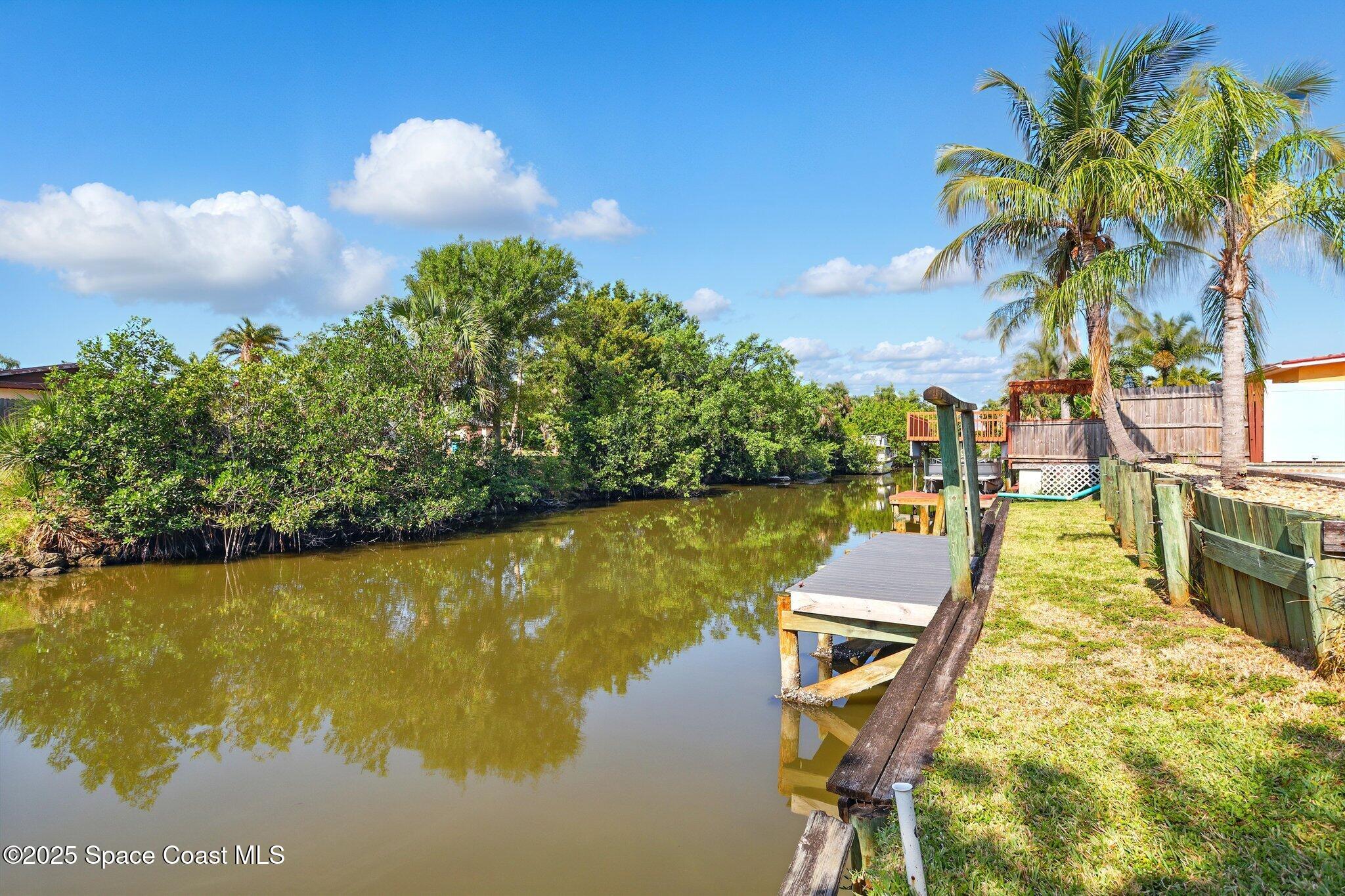 135 Richland Avenue Merritt Island, FL 32953 - Photo 5 of 24 a view of a lake with a swimming pool