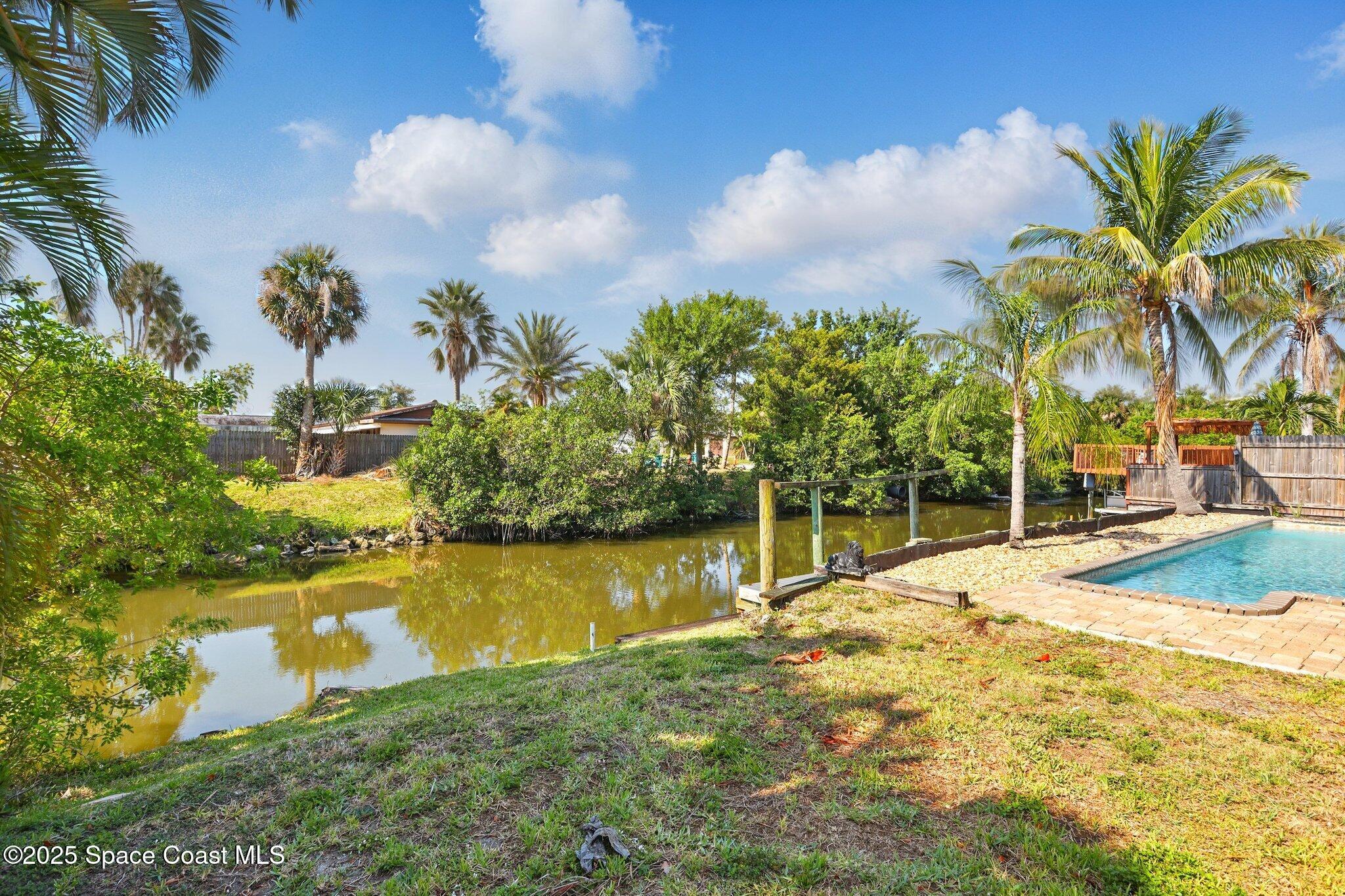 135 Richland Avenue Merritt Island, FL 32953 - Photo 7 of 24 a view of a lake with a house in the background