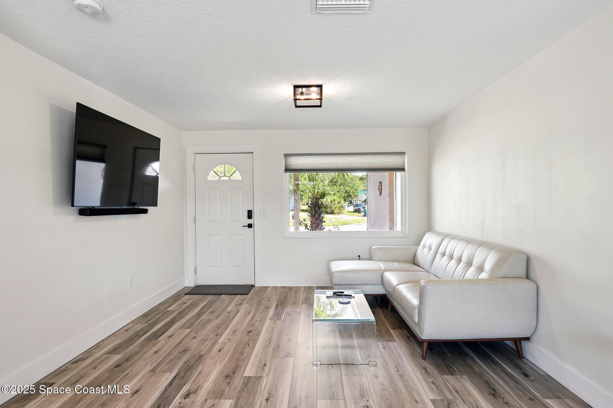 135 Richland Avenue Merritt Island, FL 32953 - Photo 10 of 24 a living room with furniture and a wooden floor