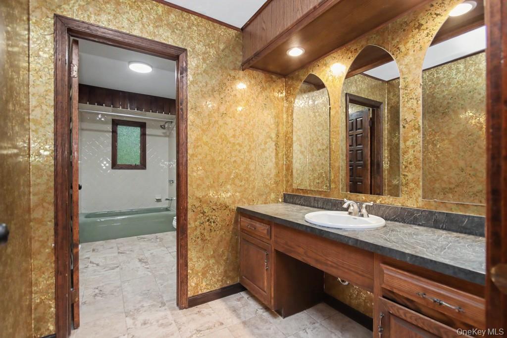 18 Hillside View Road Mahopac, NY 10541 - Photo 38 of 42 a bathroom with a granite countertop sink and a mirror