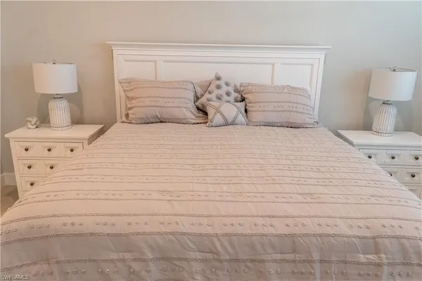 a bedroom with a bed and a lamp