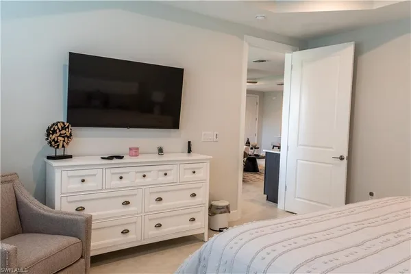 a bedroom with a bed and a flat screen tv