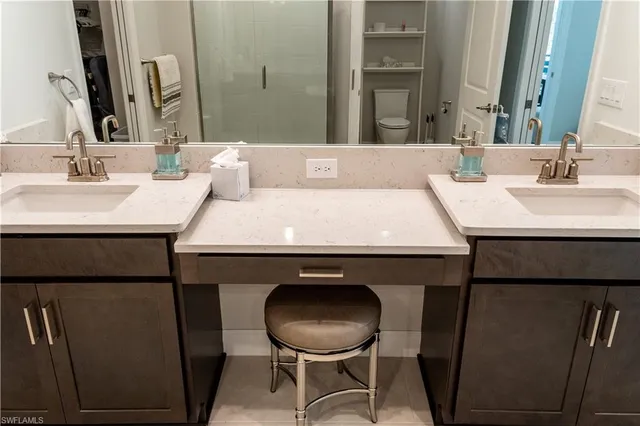 a bathroom with a sink mirror and toilet