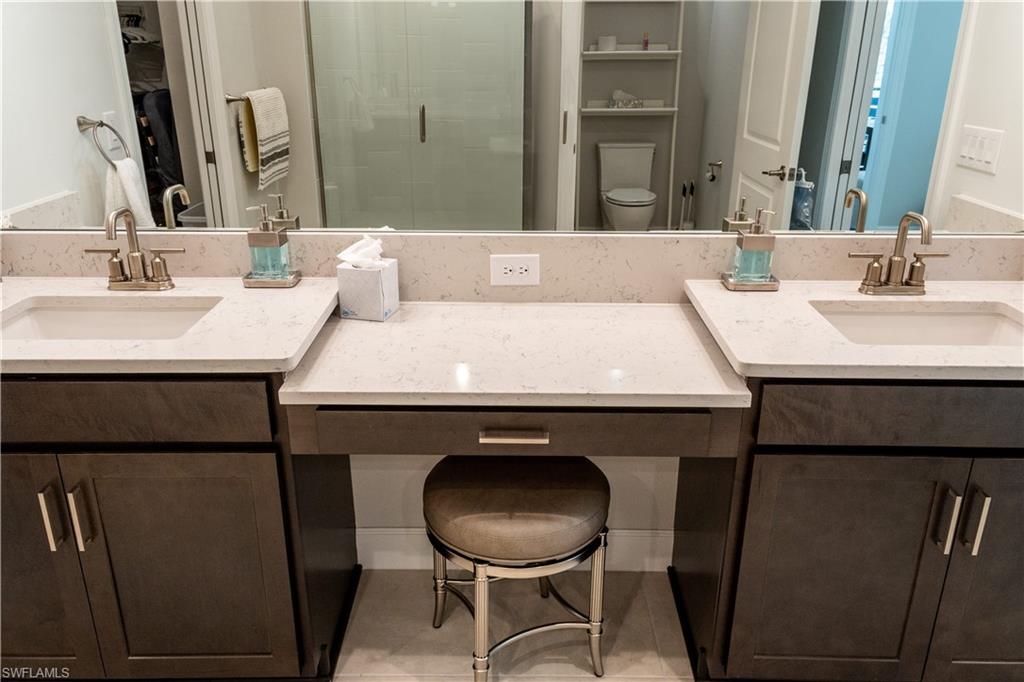 15335 Lucerna Street, Unit 104 Naples, FL 34114 - Photo 18 of 44 a bathroom with a sink mirror and toilet