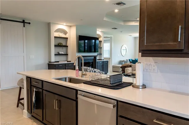 a kitchen with a sink and a refrigerator