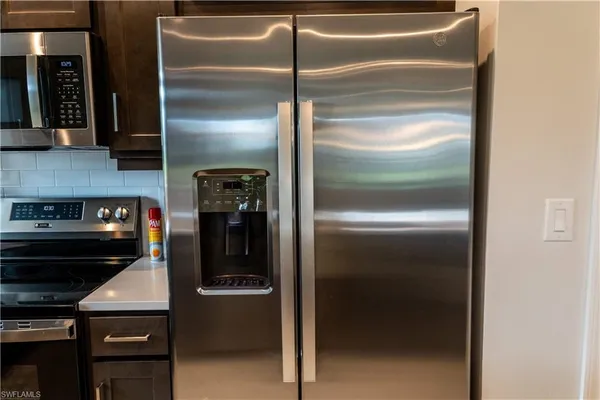a kitchen with a refrigerator and a stove