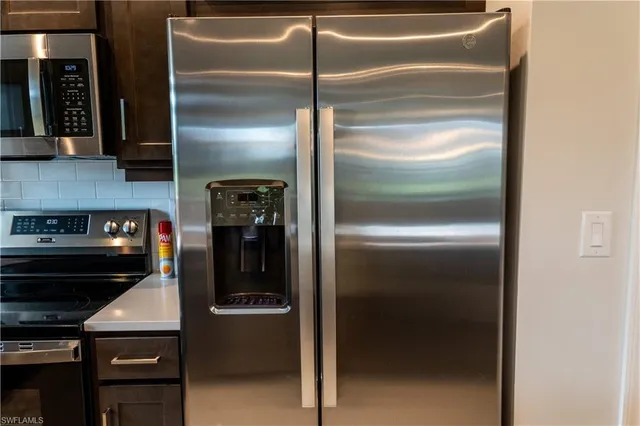 a kitchen with a refrigerator and a stove