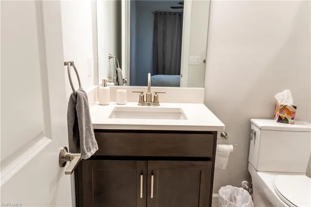a bathroom with a sink toilet and mirror