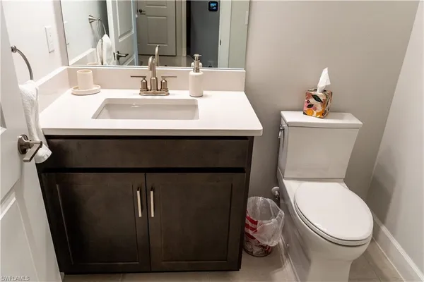 a bathroom with a sink toilet and mirror