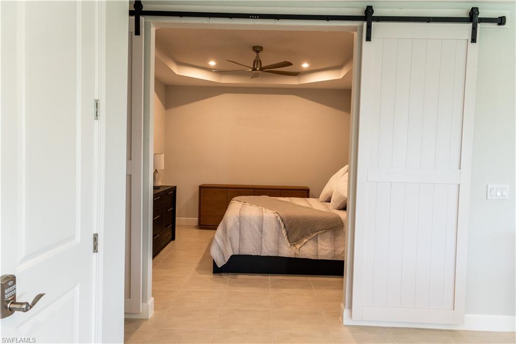 15335 Lucerna Street, Unit 104 Naples, FL 34114 - Photo 33 of 44 a bedroom with a bed and a window