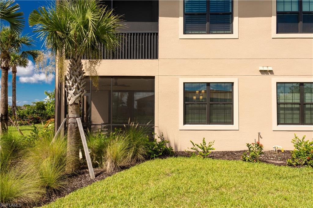 15335 Lucerna Street, Unit 104 Naples, FL 34114 - Photo 35 of 44 a front view of a house having yard