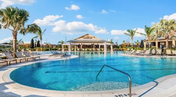 a view of a swimming pool with outdoor seating