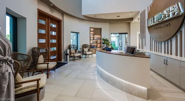 a living room with furniture a flat screen tv and a window