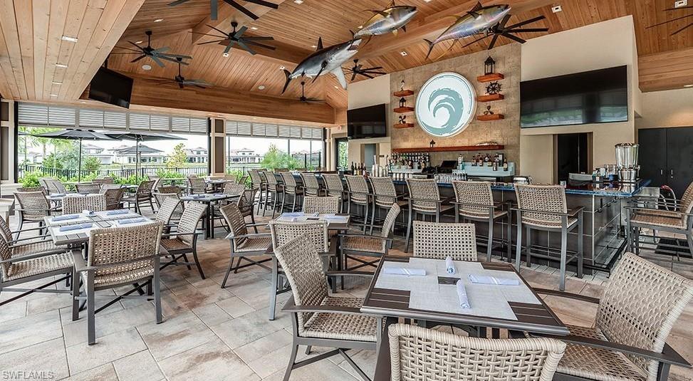 15335 Lucerna Street, Unit 104 Naples, FL 34114 - Photo 4 of 44 a living room with lots of furniture and a large window