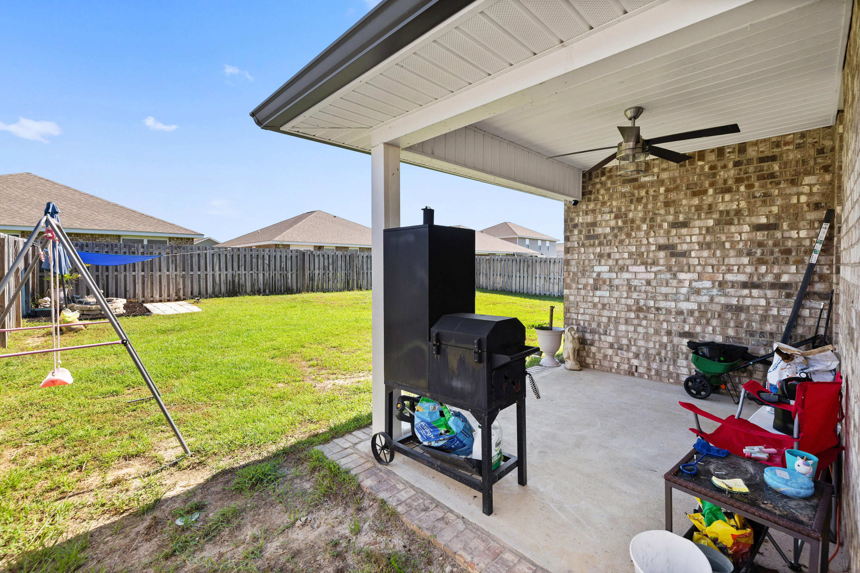 1016 Limpkin Street Crestview, FL 32539 - Photo 11 of 60 a living room with fireplace furniture and a flat screen tv