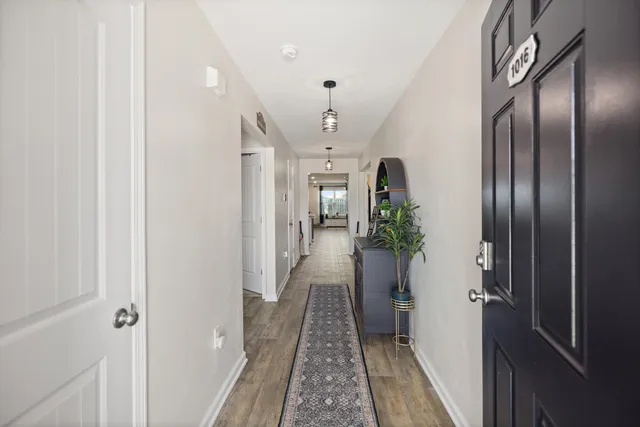 a kitchen with stainless steel appliances kitchen island granite countertop a refrigerator and a sink
