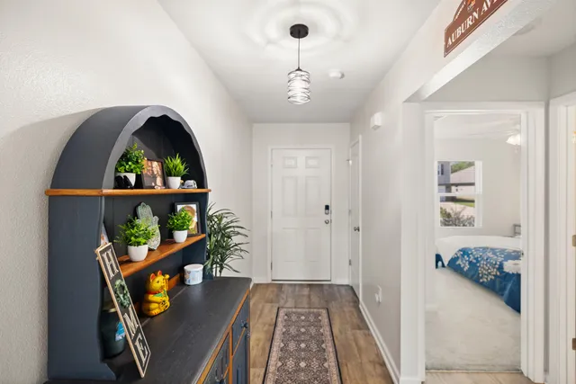 a kitchen with granite countertop a sink and refrigerator